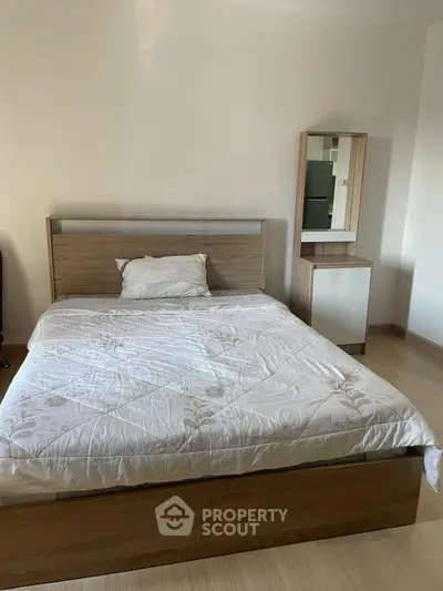Cozy bedroom with wooden bed frame and matching dresser, perfect for restful nights.