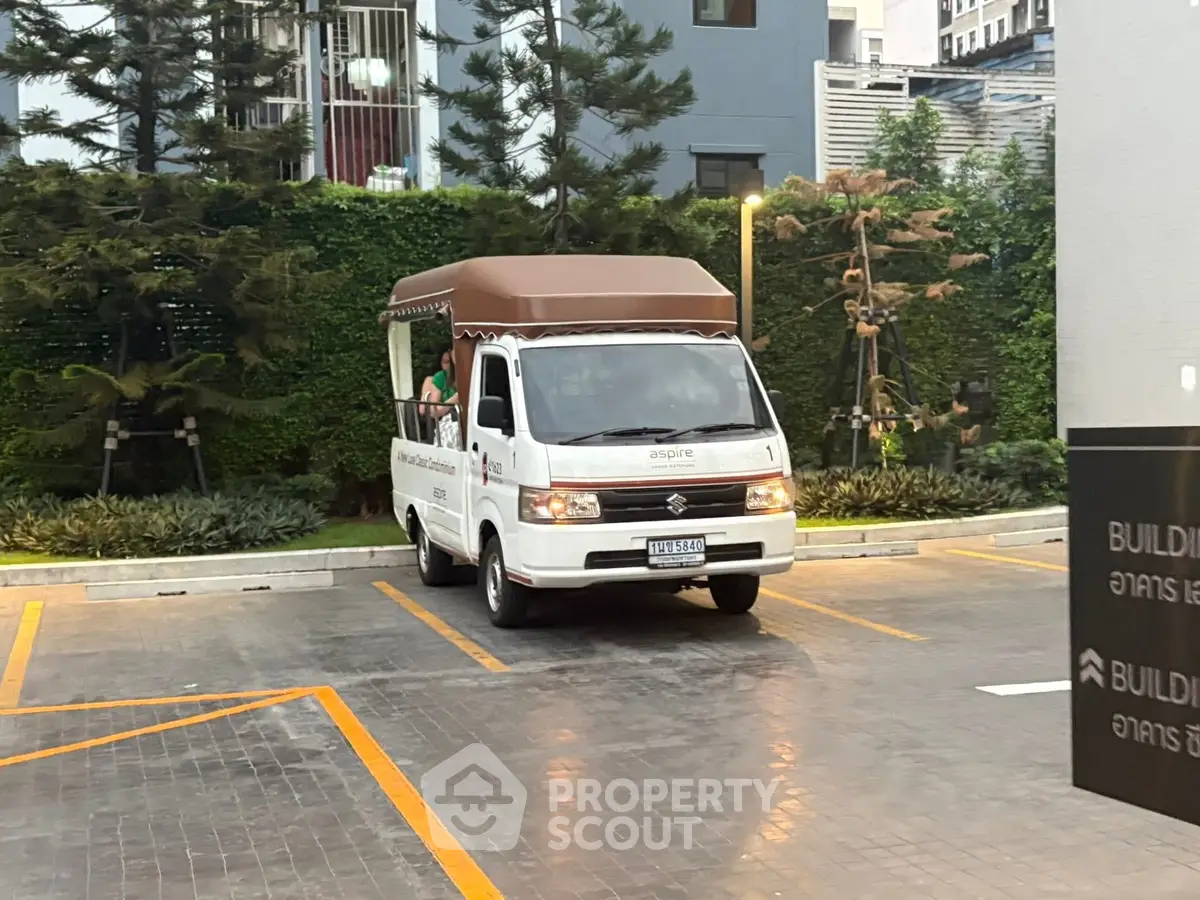 Modern building entrance with shuttle van in landscaped area