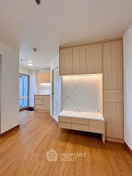 Modern apartment interior with wooden flooring and built-in storage cabinets