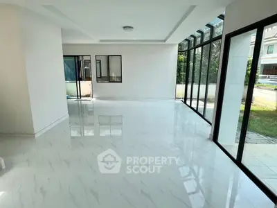 Spacious modern living room with large windows and garden view