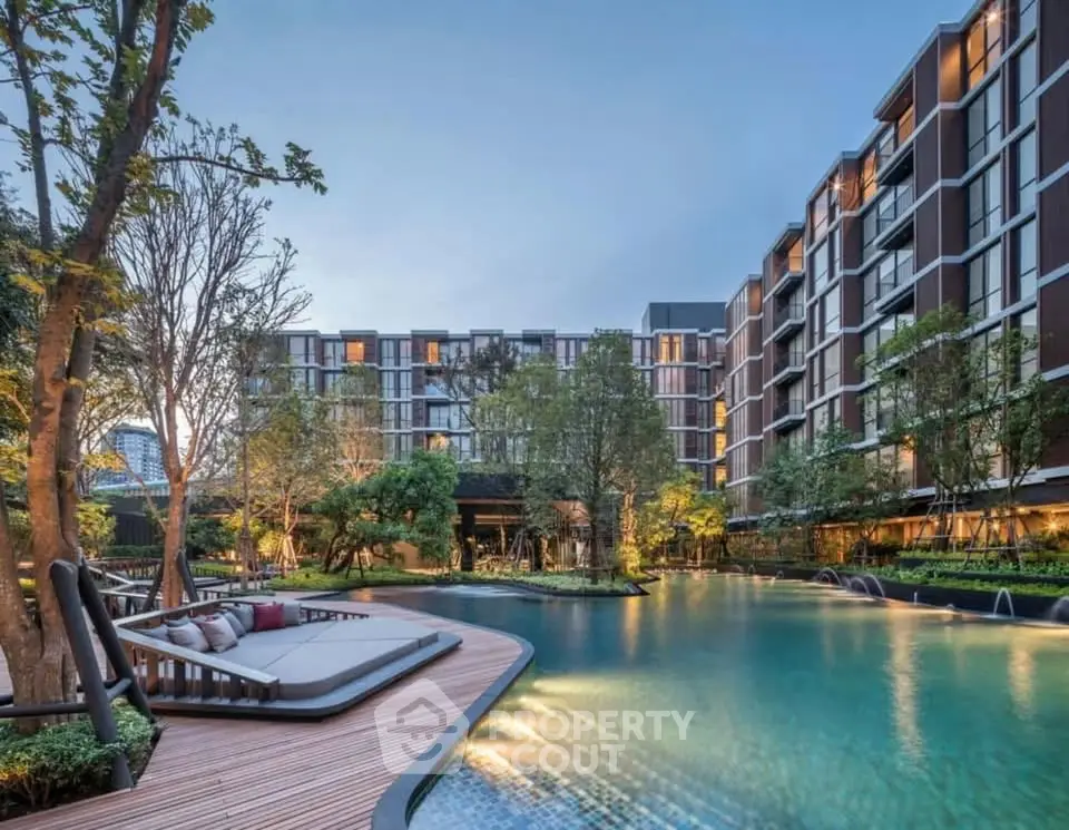 Luxurious residential complex with stunning pool and lush landscaping, perfect for modern living.