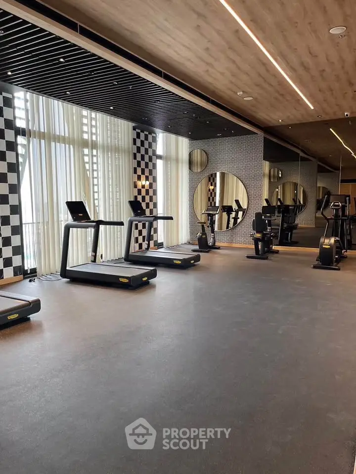 Modern gym with treadmills and stylish decor in luxury building