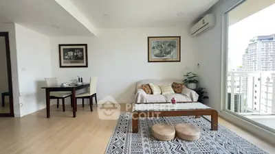 Spacious living room with modern decor and balcony view in urban apartment