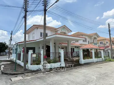 Charming suburban house with red-tiled roof and spacious front yard, perfect for family living.