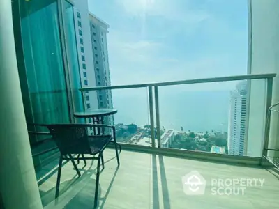 Stunning high-rise balcony with breathtaking ocean view and modern outdoor seating, perfect for relaxation.