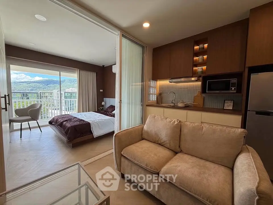 Modern studio apartment with open layout, featuring cozy living area and scenic balcony view.