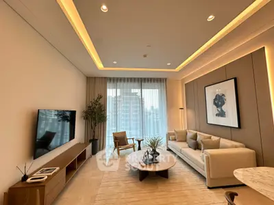 Luxurious modern living room with elegant decor and large windows offering city views.