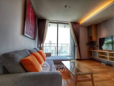 Modern living room with large windows and city view, featuring stylish furniture and vibrant decor.