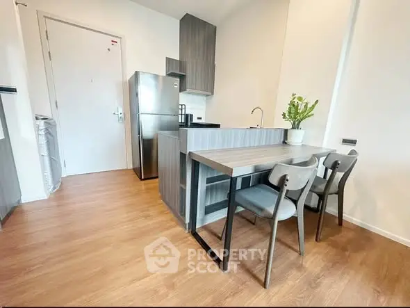 Modern kitchen with sleek design, featuring stainless steel appliances and stylish dining area.