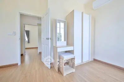 Bright and airy bedroom with modern wooden flooring and stylish furniture