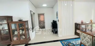 Spacious living area with elegant wooden cabinets and decorative rug