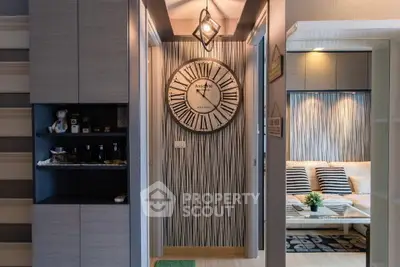 Stylish modern apartment interior with unique wall clock and cozy living area.