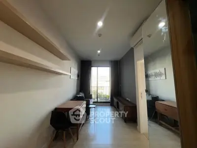 Modern living room with sleek furniture and large window for natural light