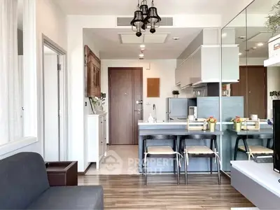 Modern open-layout kitchen and living area with stylish decor and natural light.
