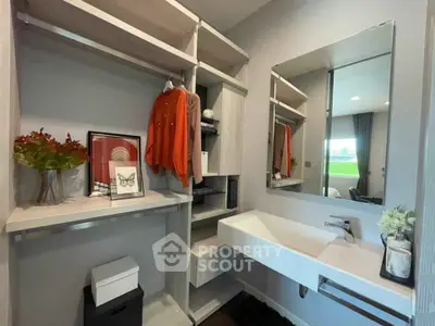 Modern bathroom with sleek sink and open shelving for storage