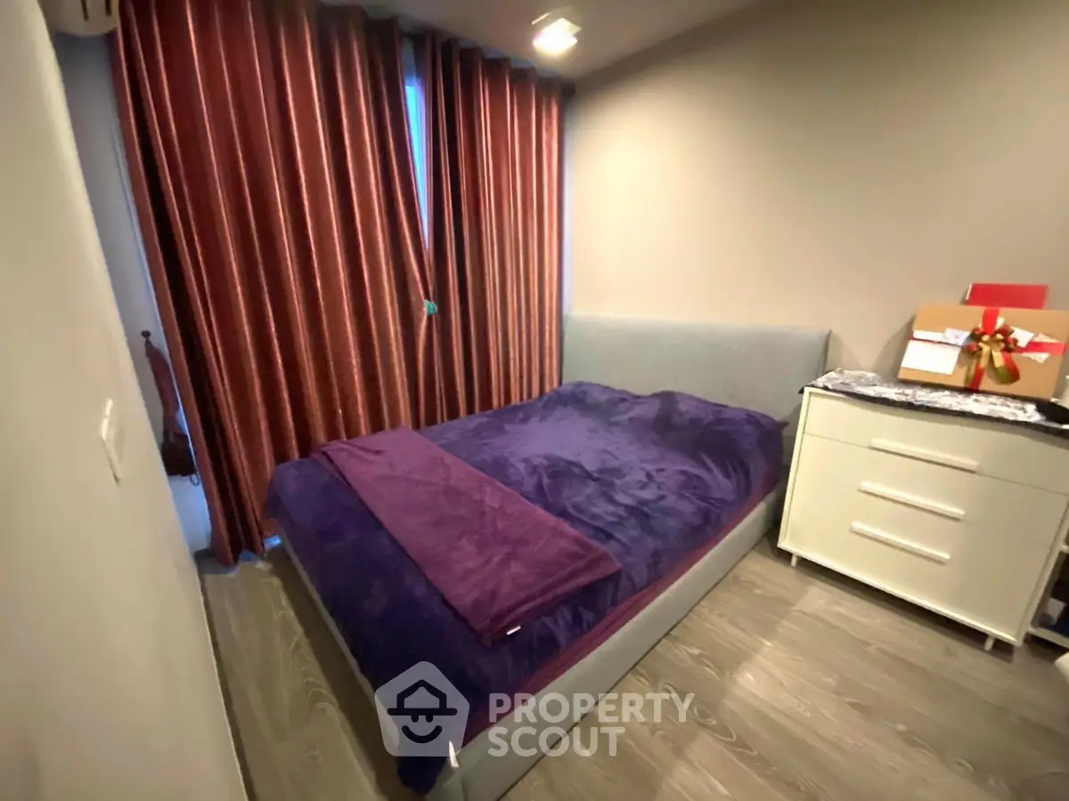 Cozy bedroom with modern decor and plush bedding in a stylish apartment.