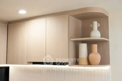 Modern kitchen with stylish wooden cabinets and decorative vases