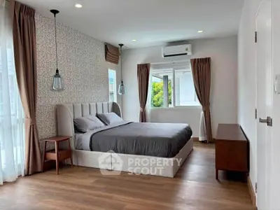 Spacious modern bedroom with elegant decor and natural light