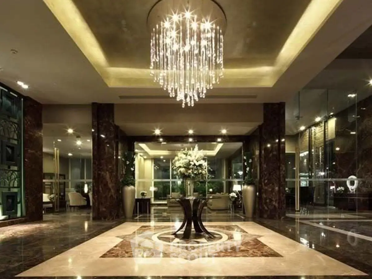 Luxurious hotel lobby with elegant chandelier and marble flooring