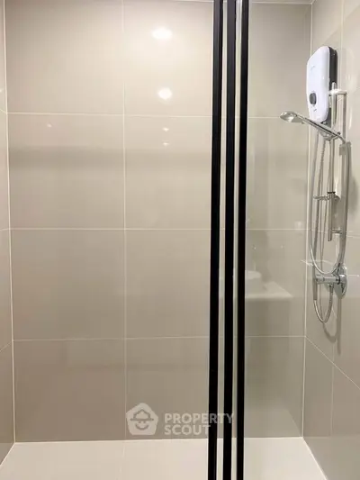 Modern bathroom with sleek shower design and neutral tiles