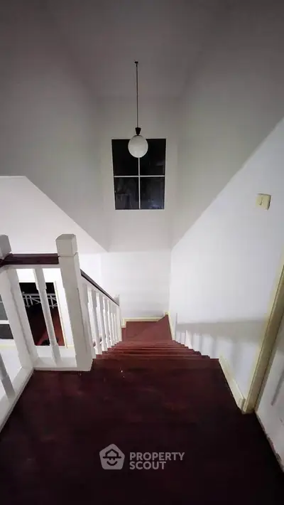Elegant staircase with dark wood steps and modern lighting in a stylish home interior.