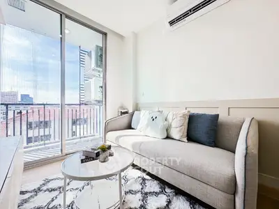 Modern living room with cozy sofa and balcony view in a stylish apartment