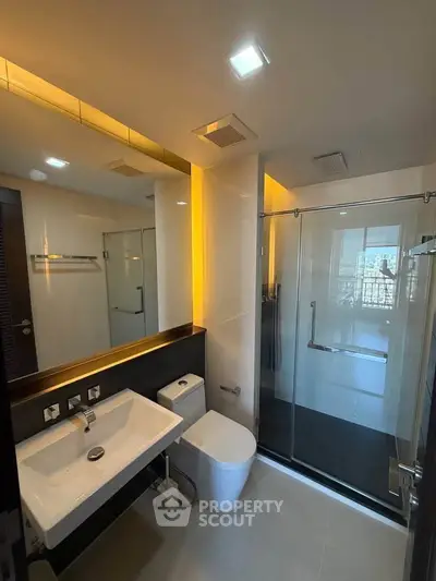 Modern bathroom with sleek fixtures and glass shower enclosure