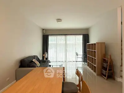 Spacious living room with modern furniture and large windows for natural light.