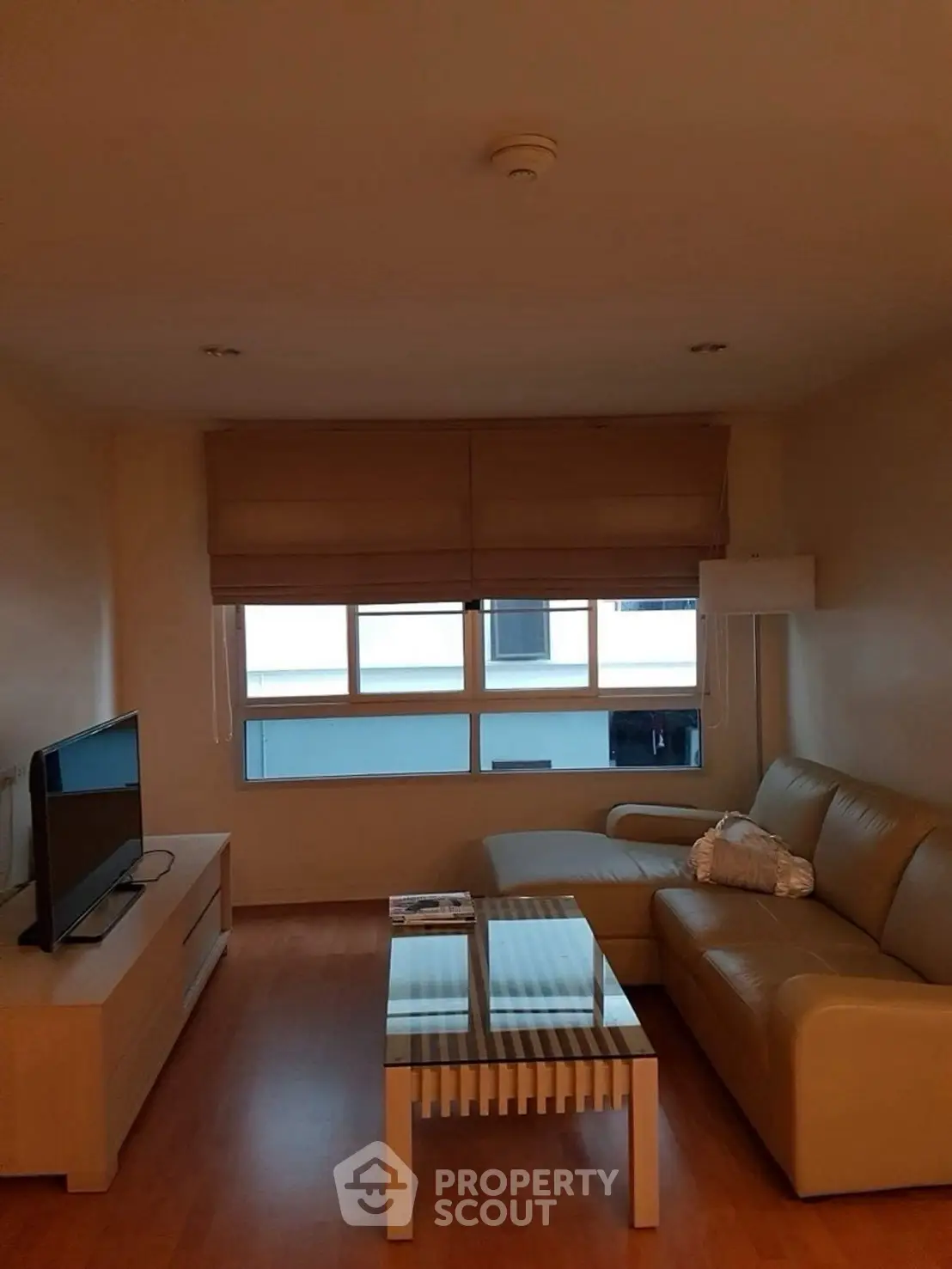Cozy living room with modern furniture and large window for natural light.