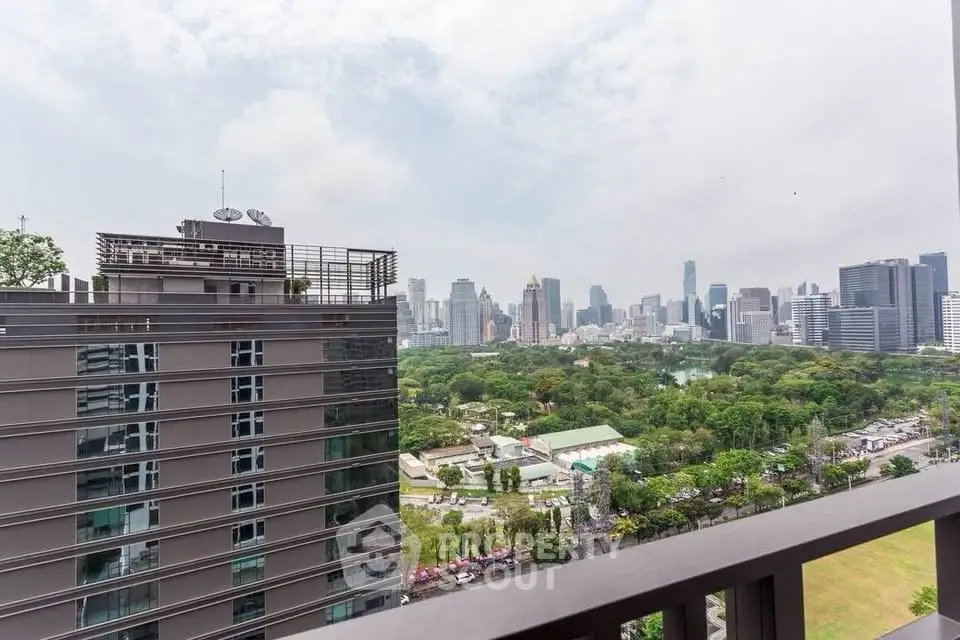 Stunning cityscape view from high-rise balcony overlooking lush park and skyline.
