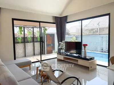 Modern living room with pool view and stylish furniture