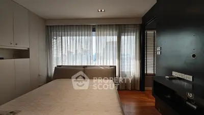 Modern bedroom with large window and stylish decor