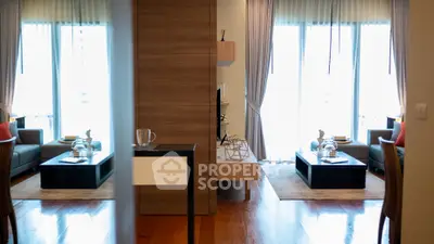 Spacious modern living room with elegant decor and large windows for natural light.
