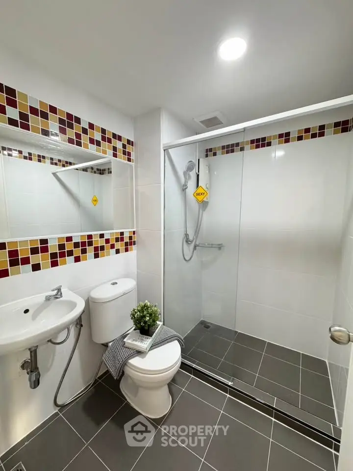 Modern bathroom with sleek shower and stylish tile accents