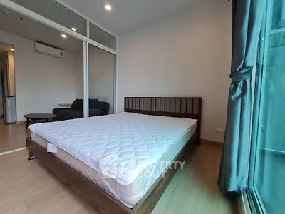 Modern bedroom with large window and minimalist design in urban apartment