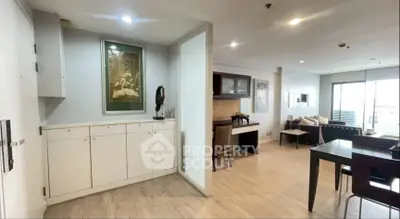 Spacious open-plan living and dining area with modern decor and ample natural light.