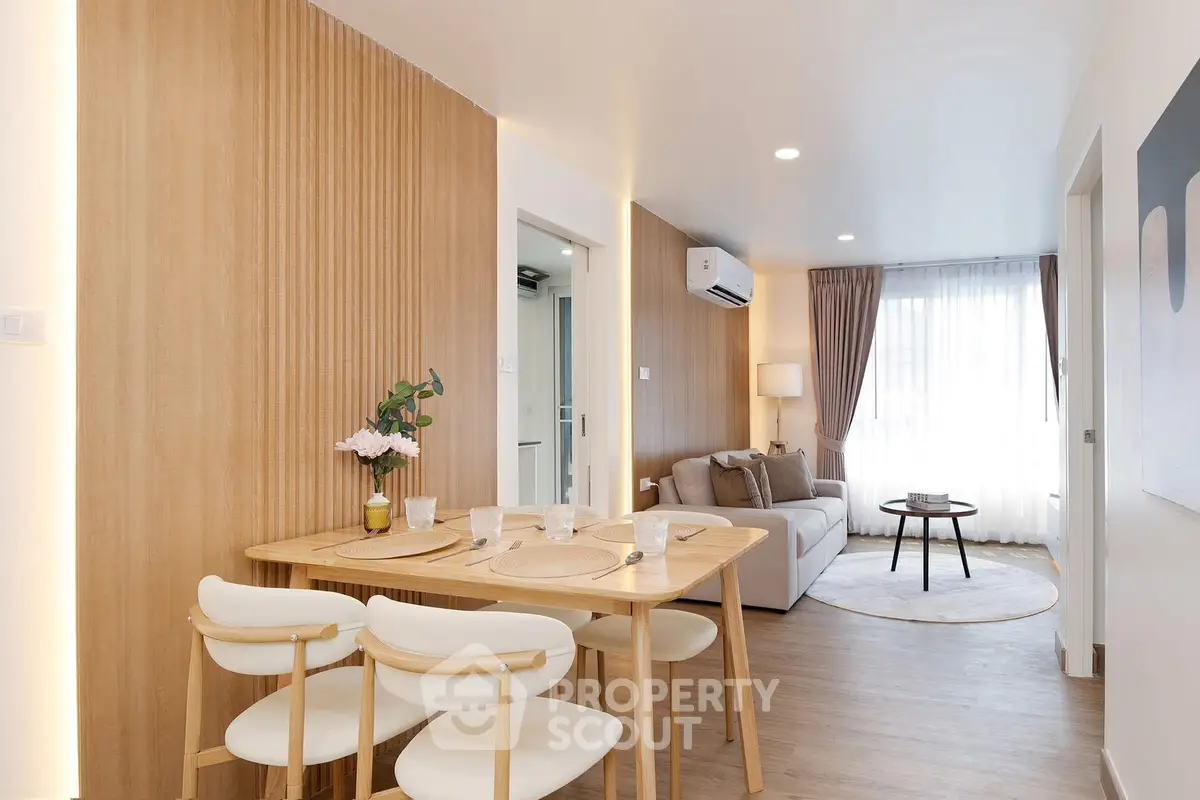 Modern living room with dining area, wooden accents, and natural light.