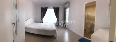 Spacious bedroom with ensuite bathroom and natural light