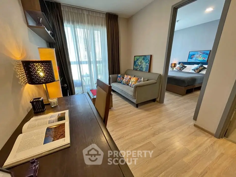 Modern apartment interior with cozy living room and stylish bedroom, featuring wooden flooring and elegant decor.
