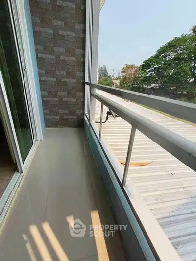 Charming balcony with sleek railing and scenic view, perfect for relaxation and enjoying the outdoors.