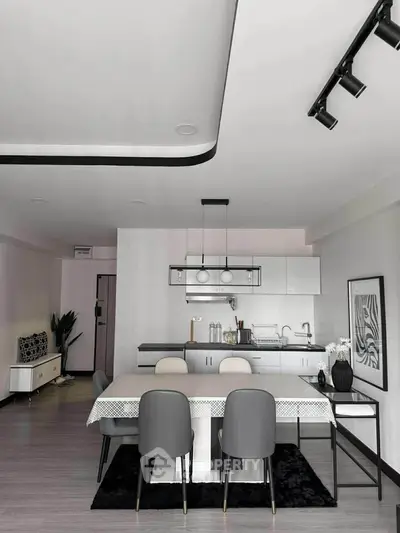 Modern dining area with sleek kitchen and stylish decor