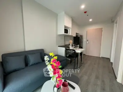 Modern living room with sleek furniture and open kitchen layout