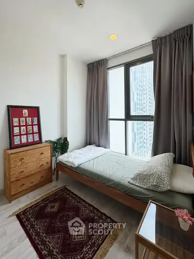 Cozy bedroom with large window and modern decor in urban apartment