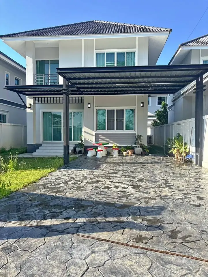 Modern two-story house with spacious driveway and landscaped garden