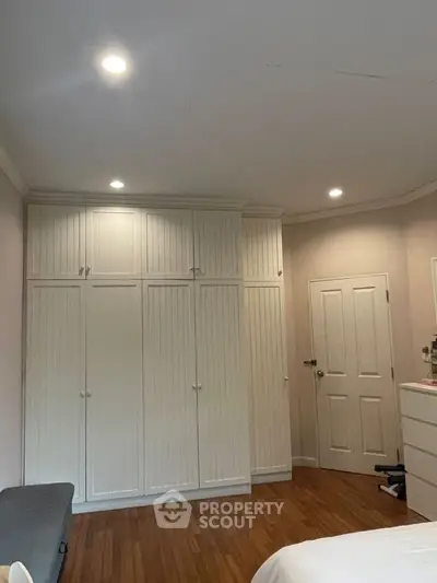 Spacious bedroom with built-in wardrobes and cozy lighting