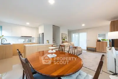 Spacious open-plan living and dining area with modern kitchen in a stylish home.