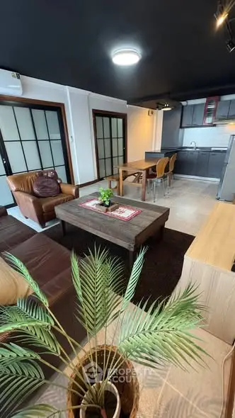 Stylish open-layout living room with modern kitchen and cozy seating area