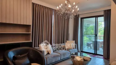 Luxurious living room with elegant chandelier and spacious balcony view