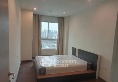 Spacious bedroom with city view in modern apartment