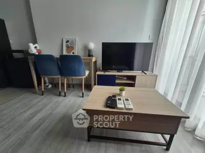 Modern living room with sleek furniture and large TV, perfect for relaxation and entertainment.